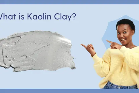 Kobieta wskazuje na grudkę szarej glinki. Dowiedz się, kaolin co to jest i jakie ma zastosowania.